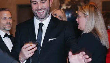 Guests toasting cocktails from the Spark mobile bar at a Sacramento event