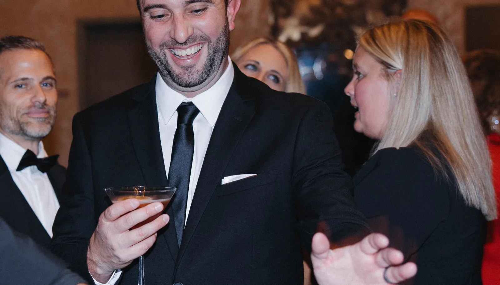 Guests toasting cocktails poured by Spark bartenders at a Sacramento event