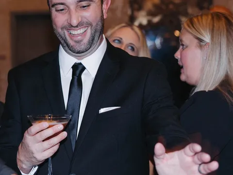 Guests toasting at a Spark event bar