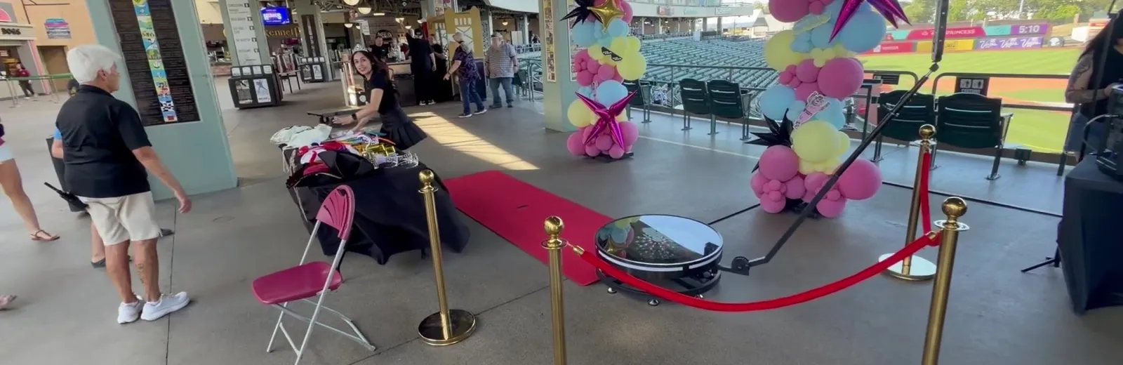 Spark 360 video booth with red carpet and balloon decor at Sutter Health Park