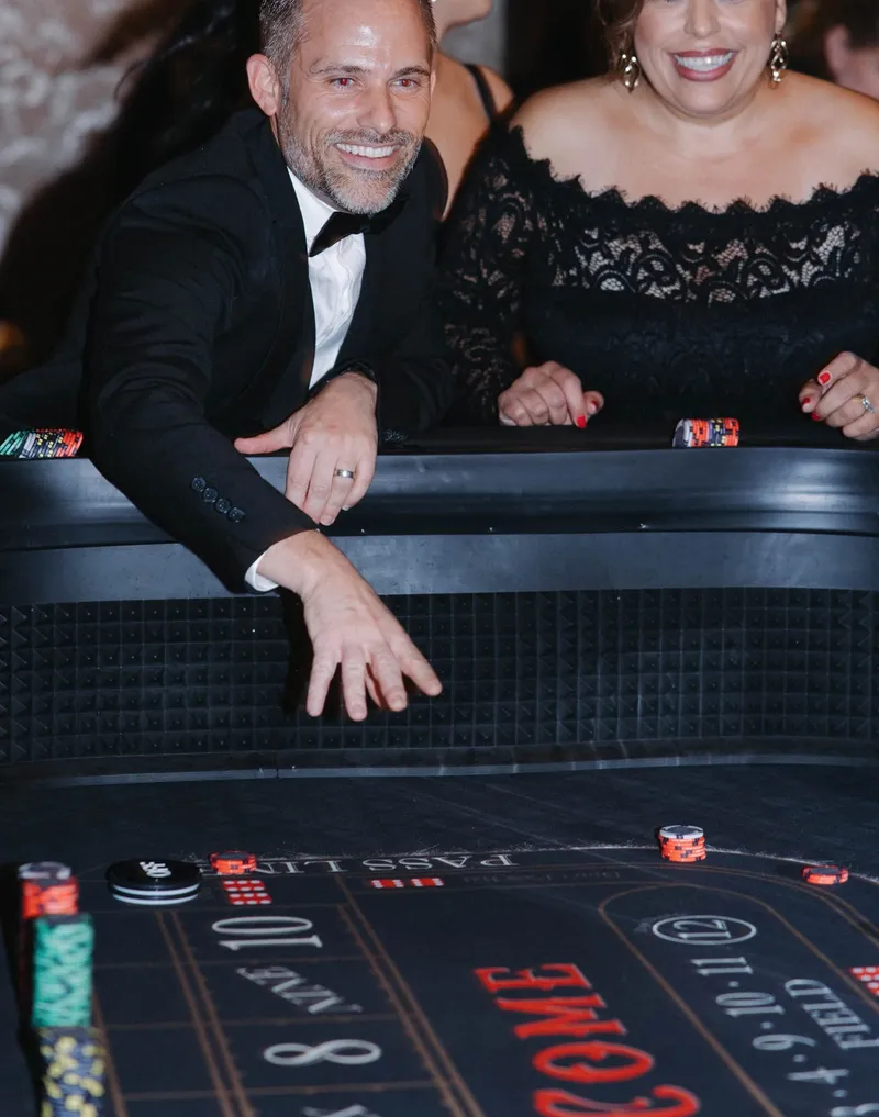 Guest throwing dice at a Spark craps table