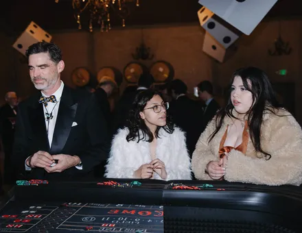 Guests at a Spark craps table at a winery gala