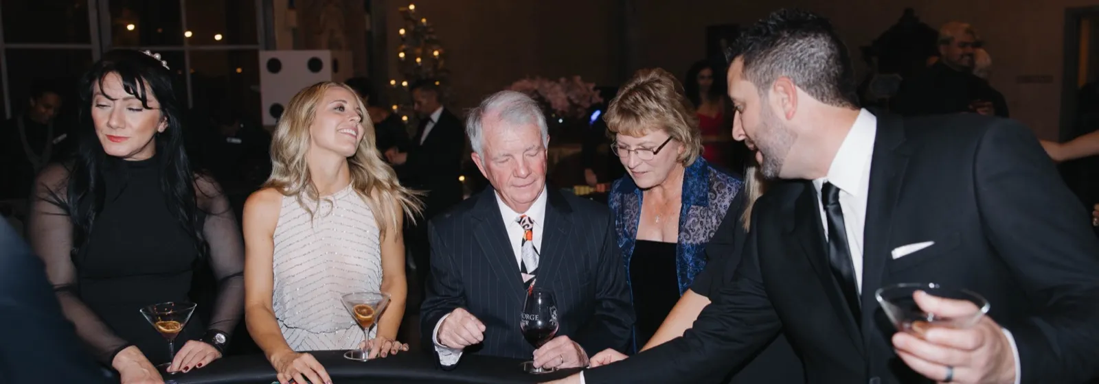 Guests in black tie playing blackjack at a real Spark casino night