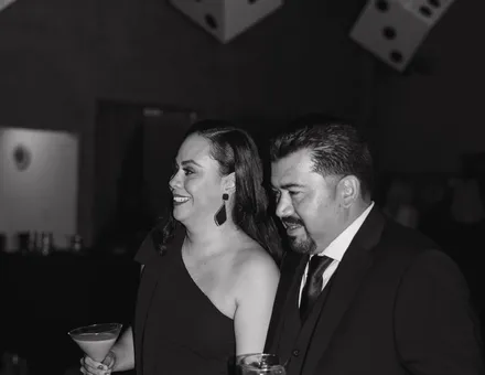 Couple in black tie at the midnight moment of a Spark casino night