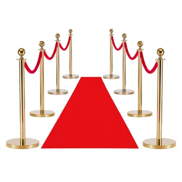 Red carpet and gold stanchions set up as the entrance to a Spark casino night party