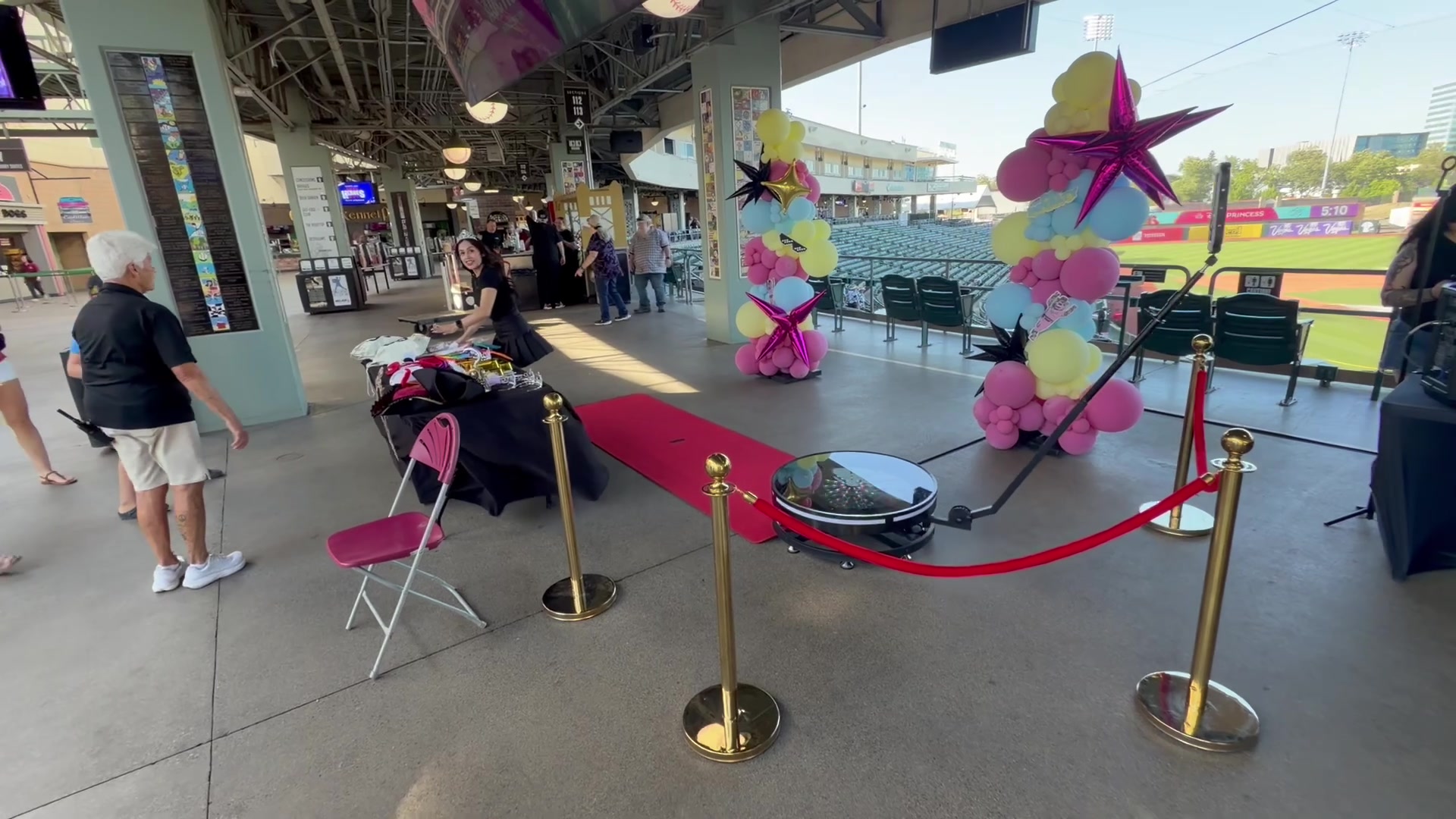 Spark 360 video booth with red carpet and balloon decor at Sutter Health Park