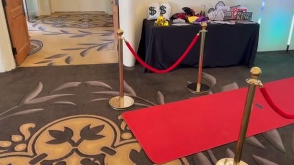 Spark red-carpet photo booth setup with props and backdrop