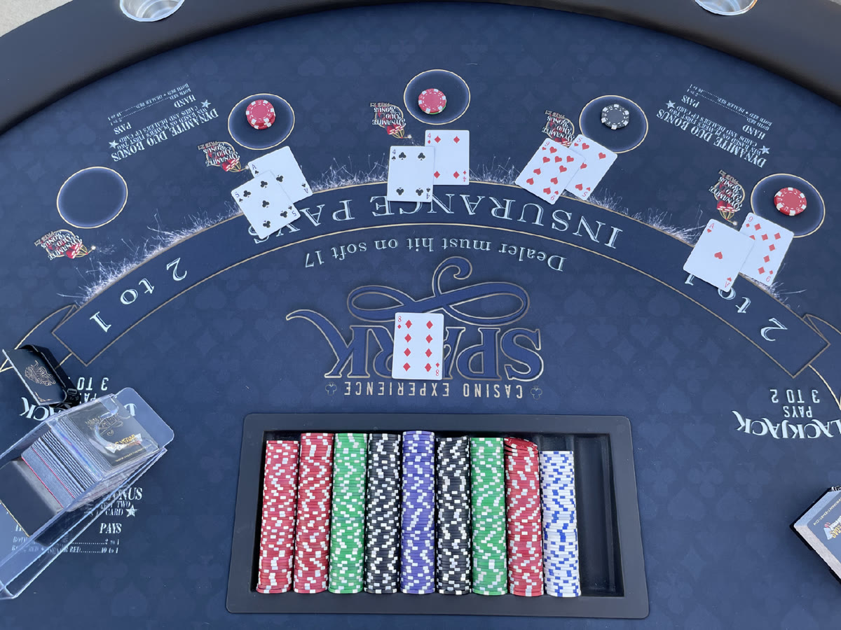 Guests playing blackjack outdoors at a backyard casino party in Sacramento