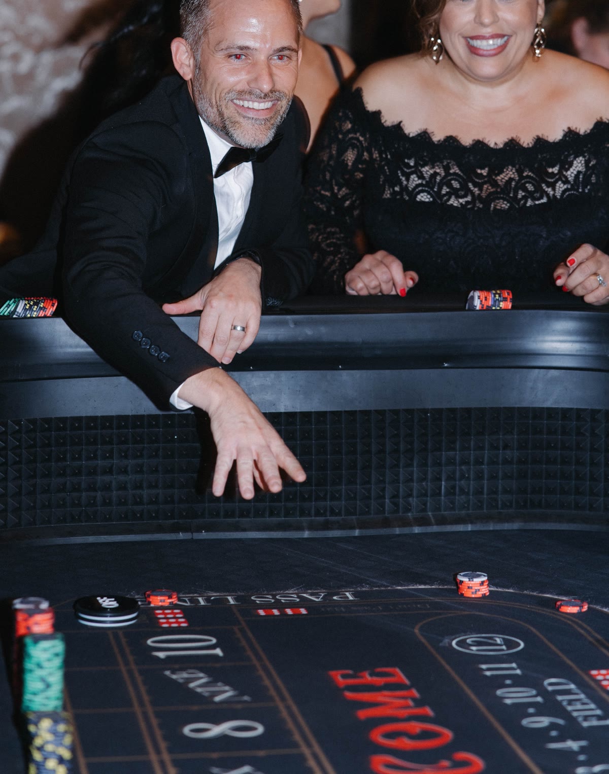 Guest throwing dice at a Spark craps table