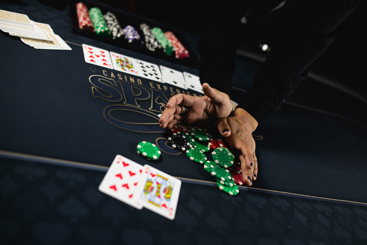 Guests playing at a Texas Hold'em tournament table during a charity poker fundraiser