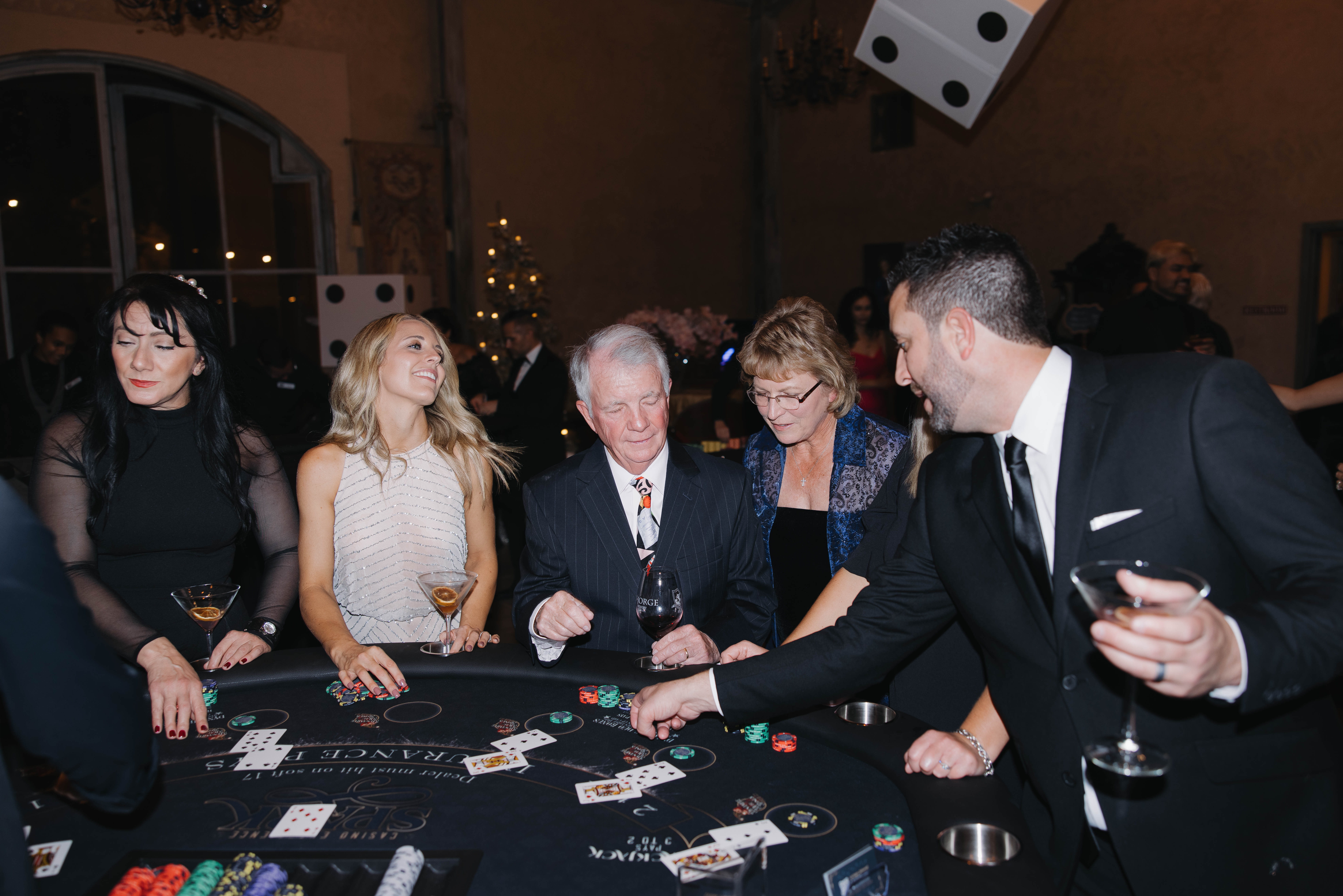 Guests in black tie playing blackjack on a custom Spark casino table